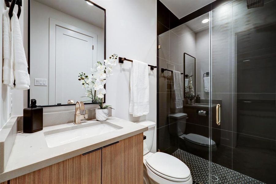 Photos are of 1502 A Ennis, the staged model at Linear on Bell. Choose from two design packages and floor plans. Stunningly luxurious black and gold tile in the first floor shower.