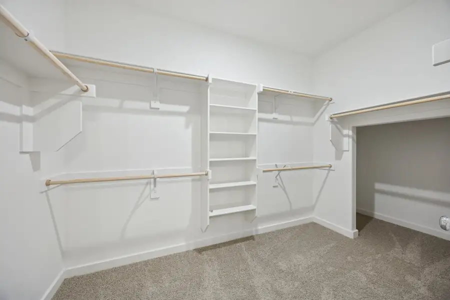 Primary Closet in the Stanley II home plan by Trophy Signature Homes – REPRESENTATIVE PHOTO Primary Closet in the Stanley II home plan by Trophy Signature Homes – REPRESENTATIVE PHOTO