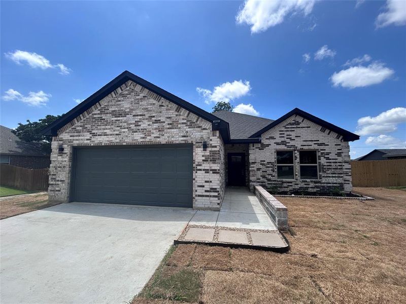 View of front of house featuring an attached garage, driveway, and brick siding View of front of house featuring an attached garage, driveway, and brick siding