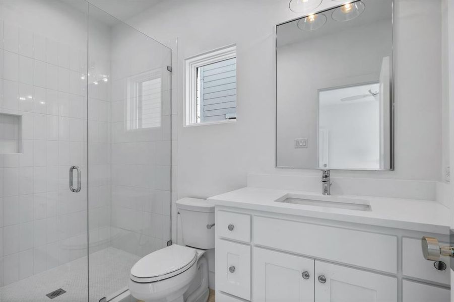 Bathroom with vanity, toilet, and walk in shower