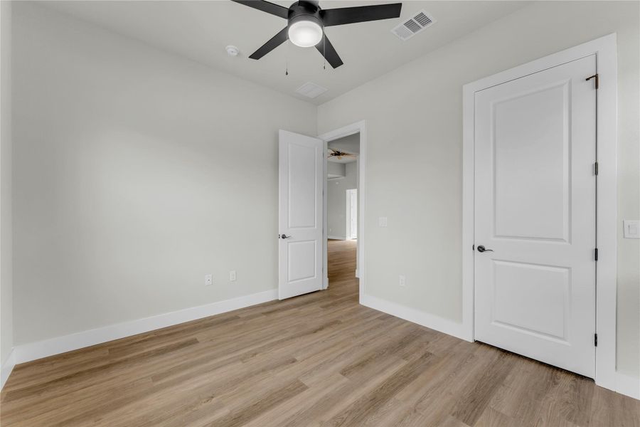 Unfurnished bedroom with light wood-style floors and ceiling fan