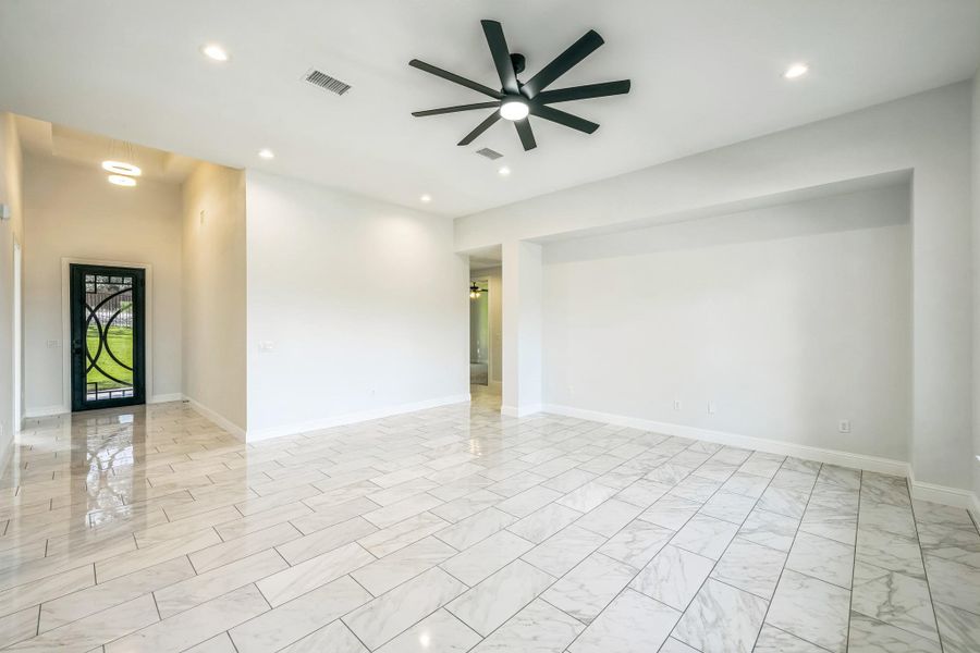 Unfurnished room featuring recessed lighting, ceiling fan, and light marble finish floors