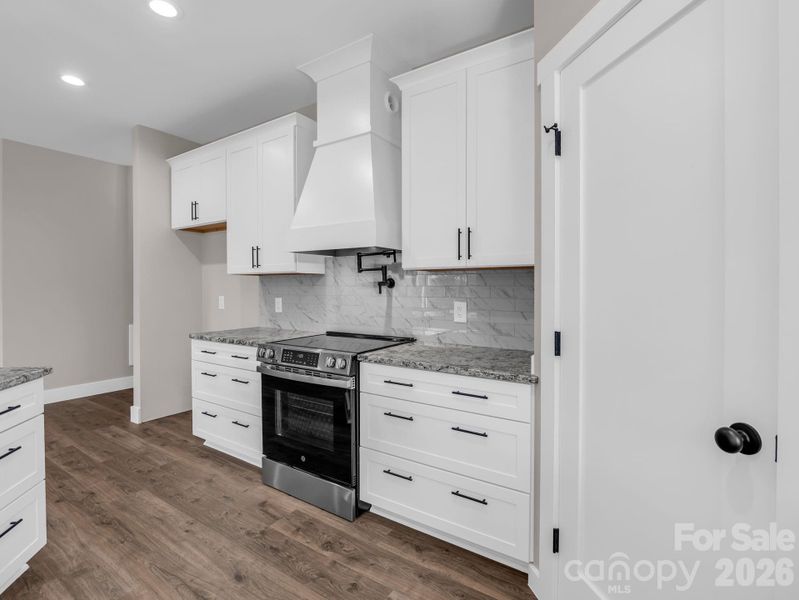 Chef's kitchen with granite counters and stainless appliances (convection electric oven, microwave drawer and dishwasher), stainless appliances, soft close cabinets, pot filler and large walk-in pantry. Chef's kitchen with granite counters and stainless appliances (convection electric oven, microwave drawer and dishwasher), stainless appliances, soft close cabinets, pot filler and large walk-in pantry.