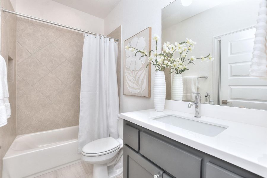 Bathroom featuring vanity and shower / bath combo