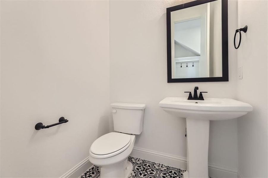 Bathroom featuring tile floors and toilet