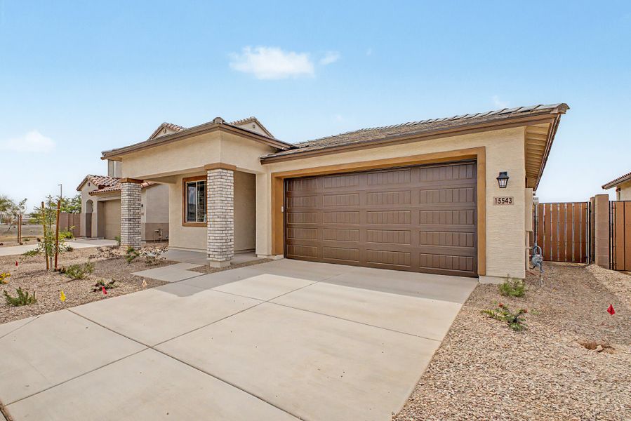Front exterior of a new home in Mason Ranch II, Surprise, AZ, highlighting curb appeal (Image 2). Front exterior of a new home in Mason Ranch II, Surprise, AZ, highlighting curb appeal (Image 2).