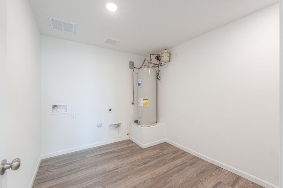A room with a wood floor and white walls.