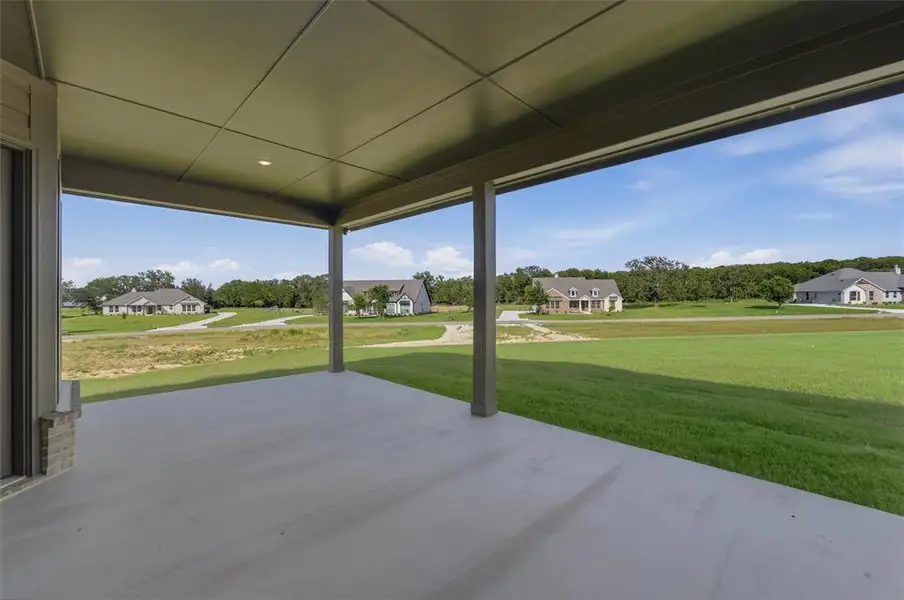 Covered patio with a concrete surface, supported by columns Covered patio with a concrete surface, supported by columns