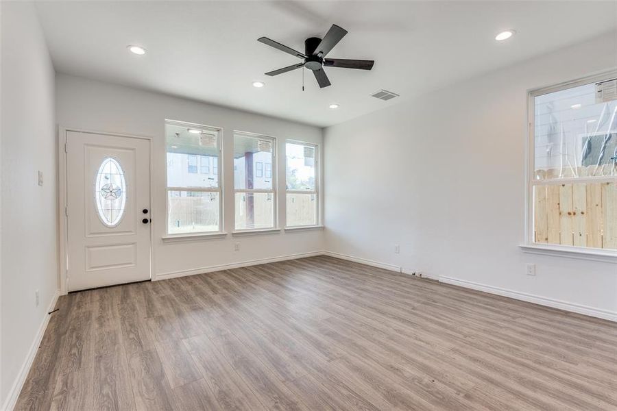 Foyer entrance featuring ceiling fan and light hardwood / wood-style floors