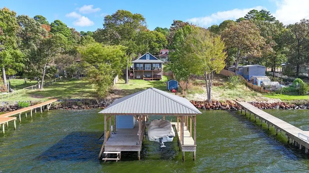 Dock area with a water view and boat lift