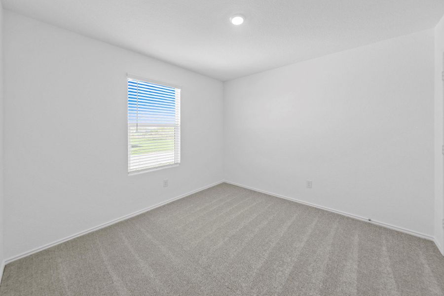 Carpeted empty room with baseboards and recessed lighting