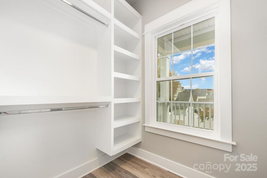 Primary closet with wooden shelves Primary closet with wooden shelves