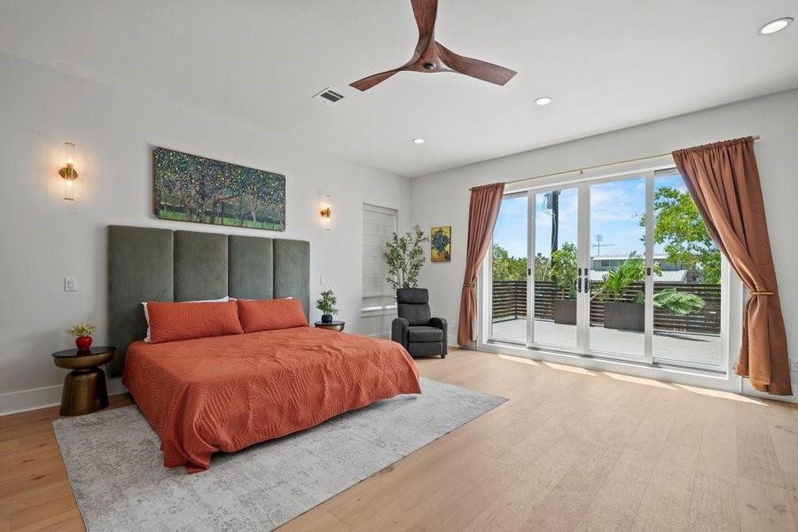 Wake up to sweeping views of Canyon Lake from this tranquil primary suite. Featuring sliding glass doors to a private balcony, warm wood floors, and a minimalist design—this space is your perfect Hill Country retreat.