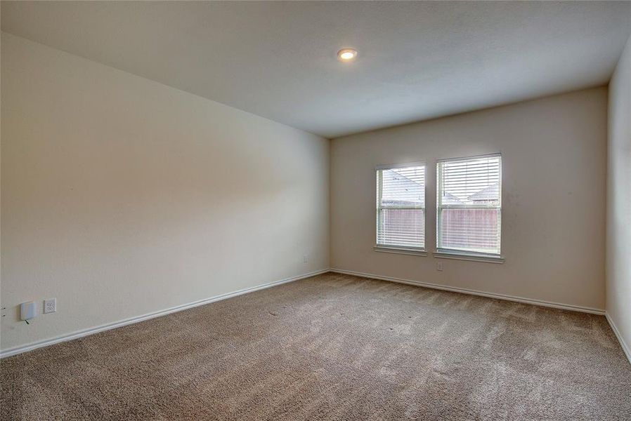 Carpeted spare room featuring baseboards and recessed lighting