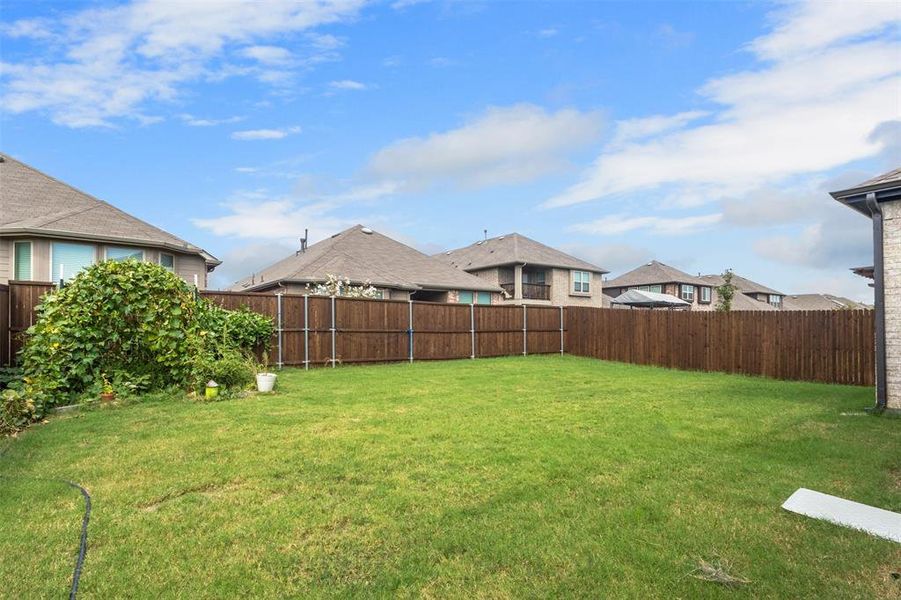 Fenced backyard with a residential view