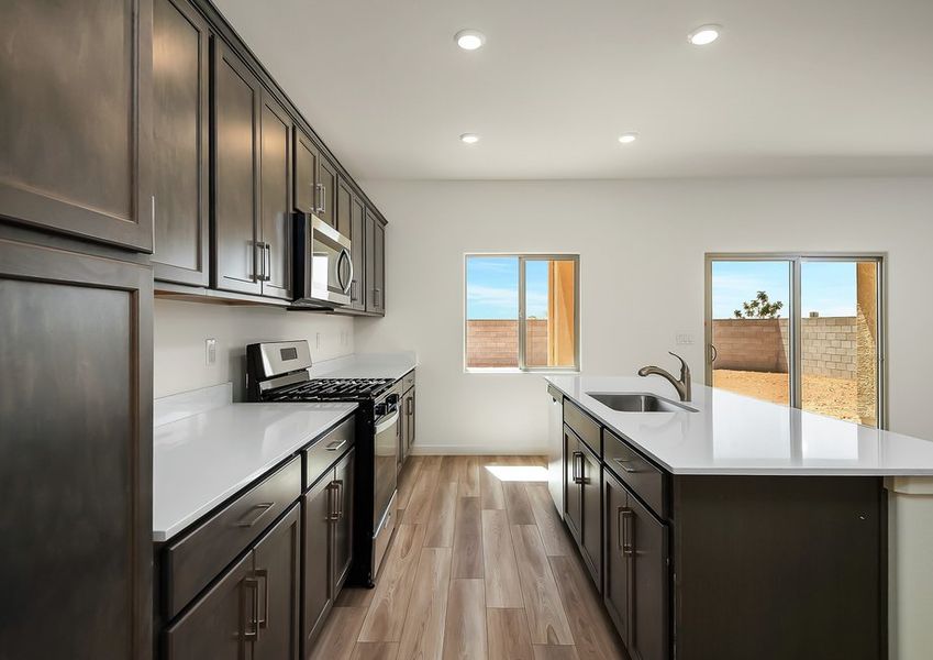Kitchen island and stainless range with quartz countertops in Wellton floor plan