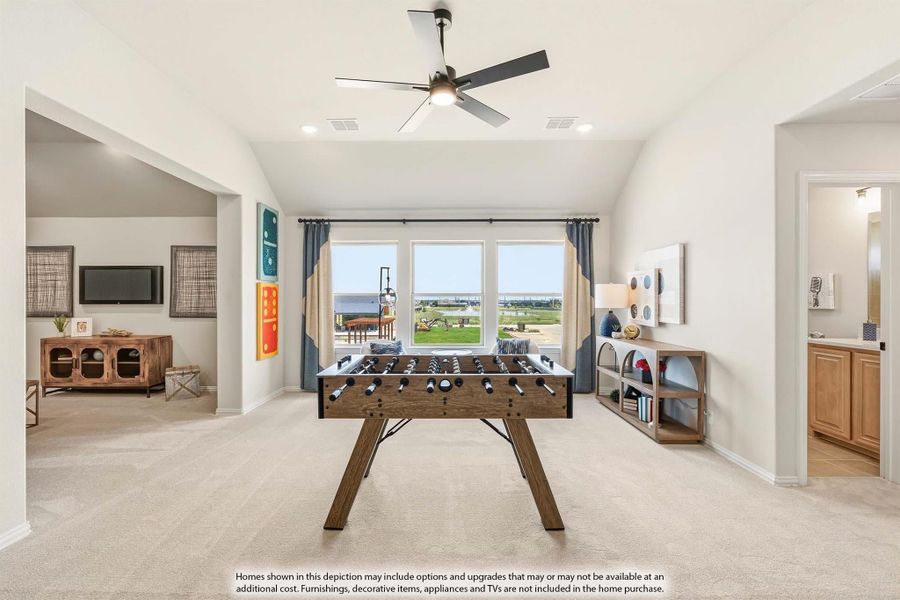 Spacious game room with foosball table, ceiling fan, carpet flooring, and open view to living area and bathroom