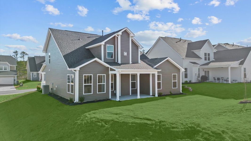 Rear covered porch creates a seamless extension of this home’s elegant design