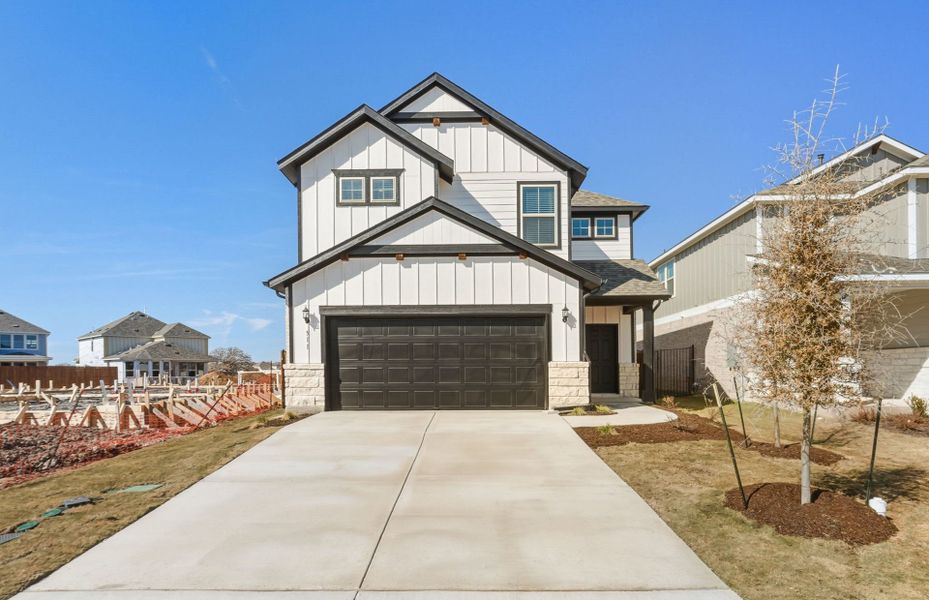Front exterior of a new home in Santa Rita Ranch, Liberty Hill, TX, highlighting curb appeal (Image 18).