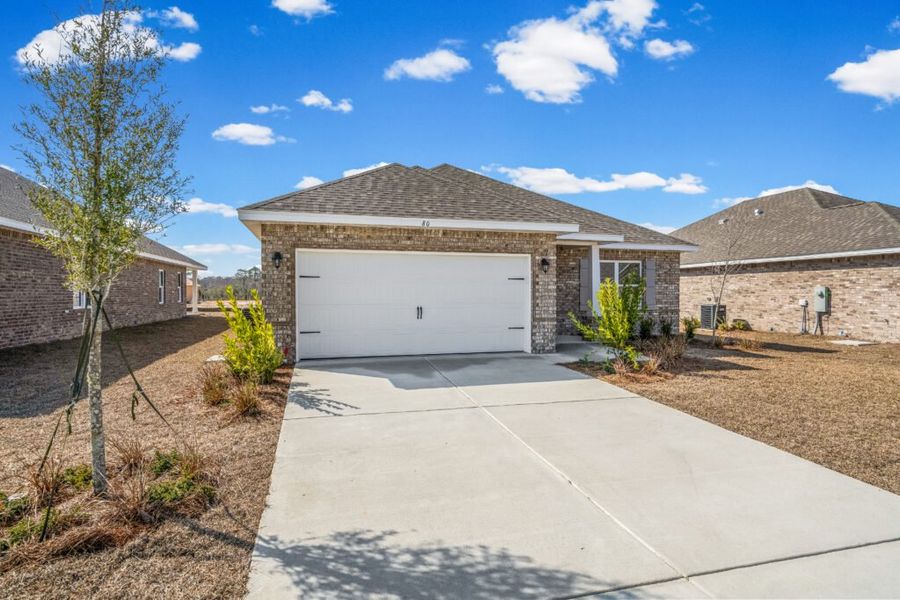 Front exterior of a new home in Natureview, Freeport, FL, highlighting curb appeal (Image 18).