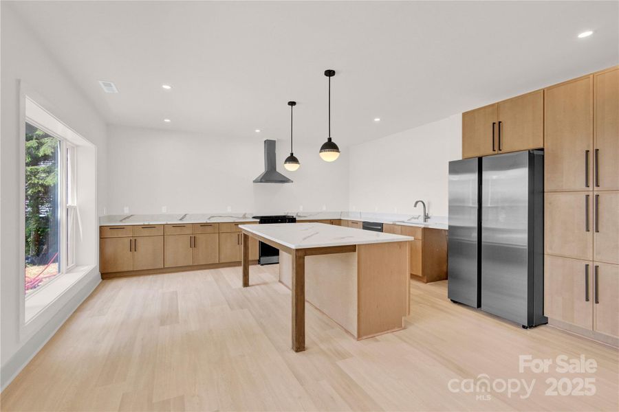 Open basement kitchen with appliances is open to great room for easy entertaining Open basement kitchen with appliances is open to great room for easy entertaining