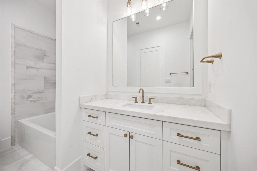 Clean, spa inspired finishes pair with a tub and shower combination designed for everyday ease. Stone countertops, generous vanity storage, and modern fixtures create a polished space that feels both timeless and practical.**Previous build by Arch Angelo** Clean, spa inspired finishes pair with a tub and shower combination designed for everyday ease. Stone countertops, generous vanity storage, and modern fixtures create a polished space that feels both timeless and practical.**Previous build by Arch Angelo**