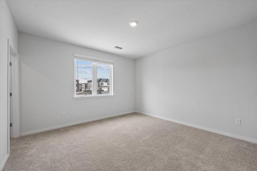 A room with a window and a carpet. A room with a window and a carpet.