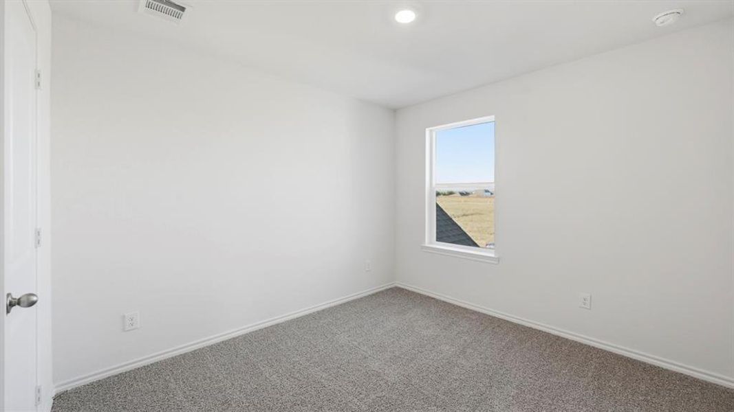 Carpeted spare room featuring baseboards and recessed lighting Carpeted spare room featuring baseboards and recessed lighting