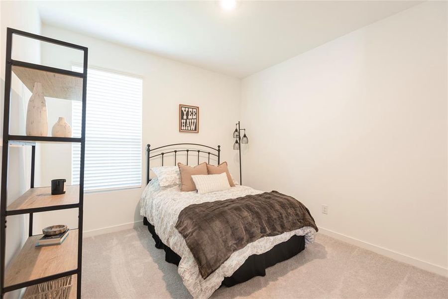 Carpeted room with a window featuring horizontal blinds, white baseboards, and a tall ceiling Carpeted room with a window featuring horizontal blinds, white baseboards, and a tall ceiling