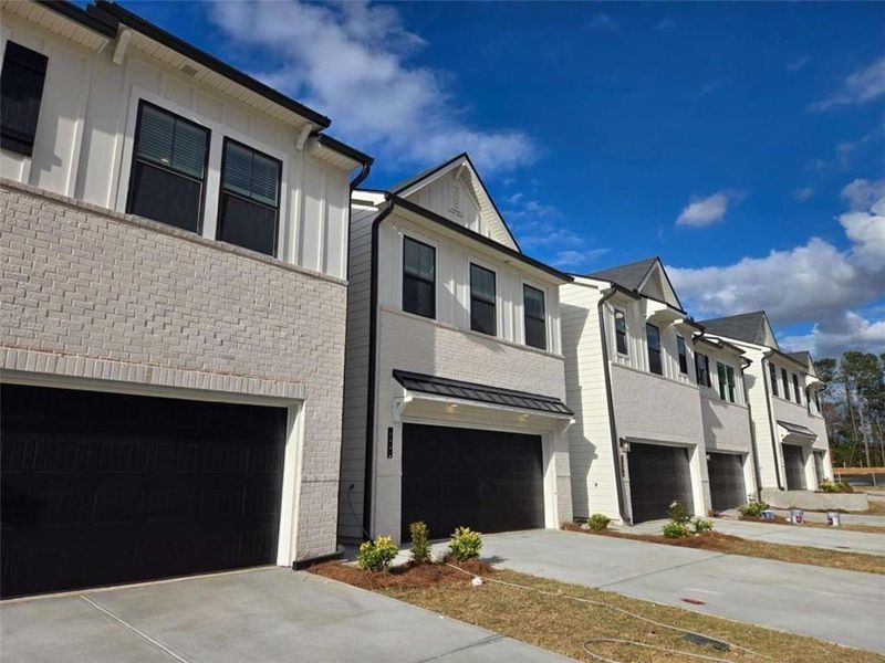 Front exterior of a new home in Azalea Square Townhomes, Lawrenceville, GA, highlighting curb appeal (Image 26).