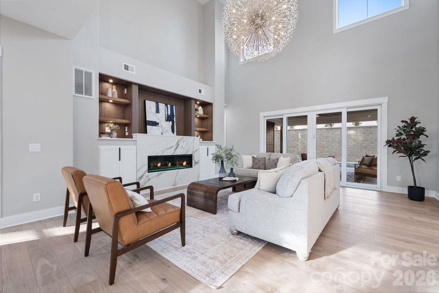 Grand two-story great room, linear gas fireplace and custom built-ins