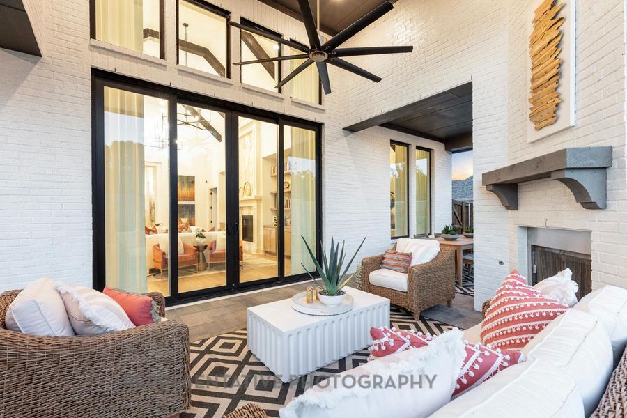 View of patio featuring ceiling fan and an outdoor living space with a fireplace View of patio featuring ceiling fan and an outdoor living space with a fireplace