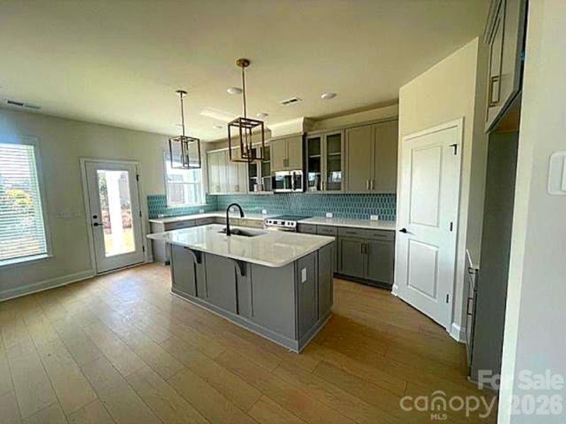 Bushwick II with 42" cabinets soft close doors & drawers, quartz countertops, Frigidaire gallery appliances, Cooking vented to the outside. LVP flooring- actual home professional photos 3/13