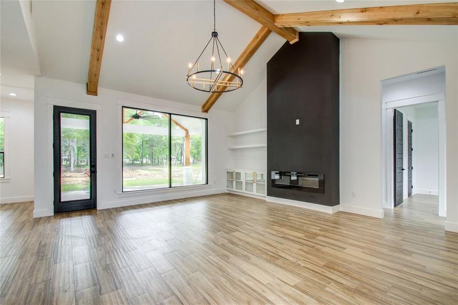 Spacious living with 16ft ceilings and oversized windows looking at your back patio (photos are from previous build, current home is about 55 days from completion)