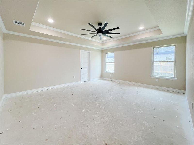 Primary room with ornamental molding, a raised ceiling, a ceiling fan, and recessed lighting Primary room with ornamental molding, a raised ceiling, a ceiling fan, and recessed lighting
