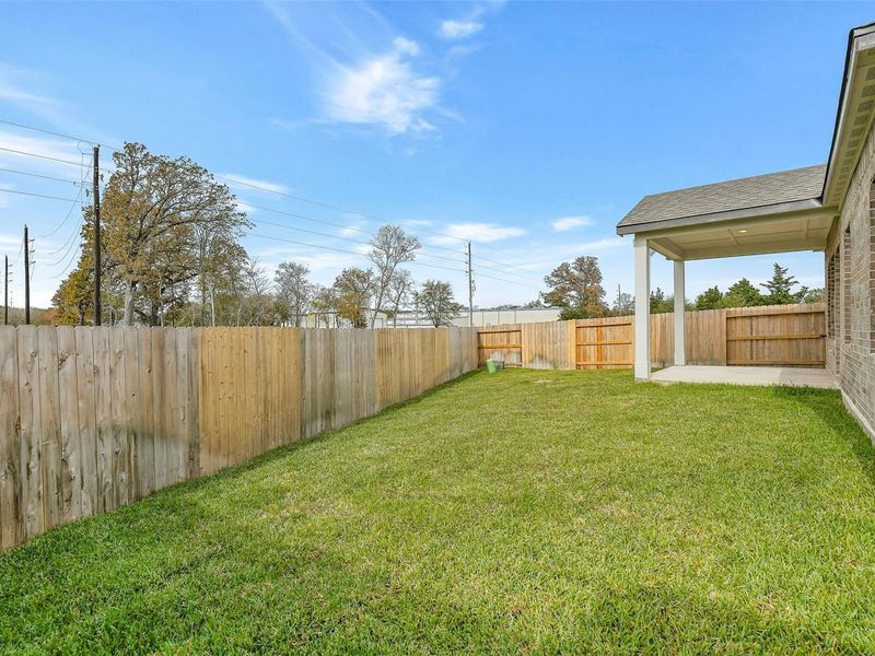 Exterior details and patio area of a home in Windmill Estates, Magnolia (Image 22).