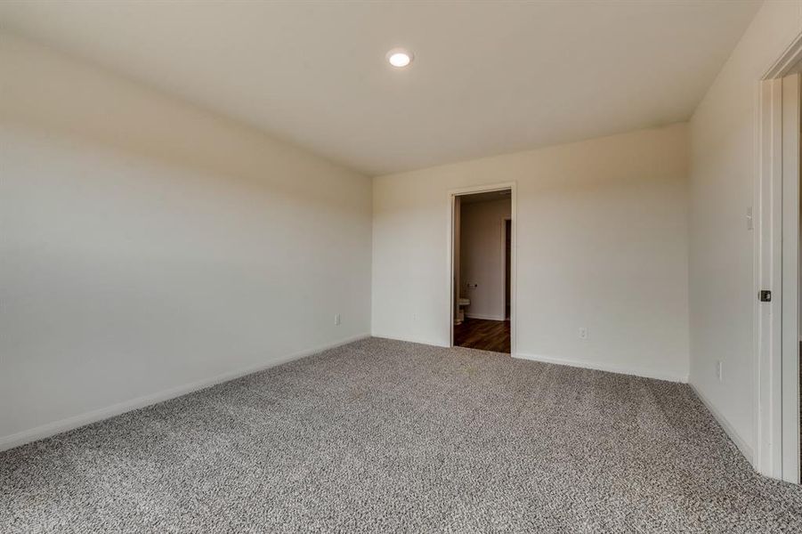 Unfurnished room with dark colored carpet