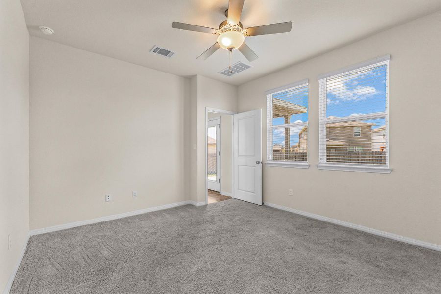 Unfurnished room with carpet flooring and a ceiling fan Unfurnished room with carpet flooring and a ceiling fan