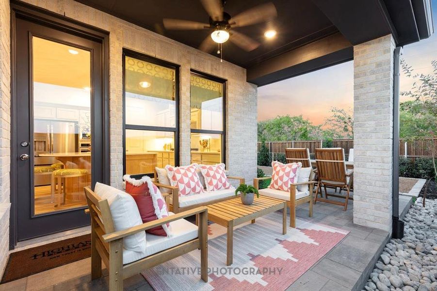 Patio terrace at dusk with outdoor lounge area, ceiling fan, and a patio