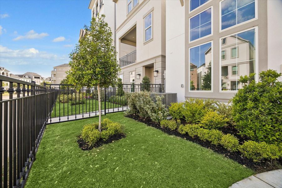 A nice size front yard to Enjoy. Enclosed with a beautiful black wrought iron fence, and gate in the front.