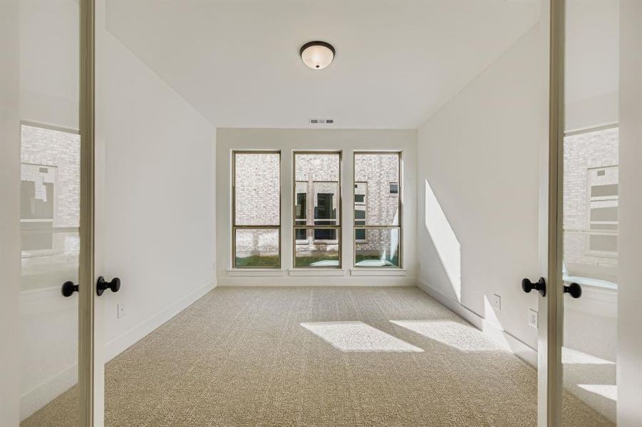 Spare room with carpet and french doors