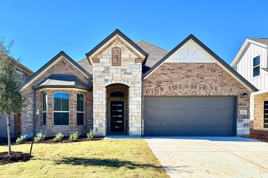 Front exterior of a new home in The Hills of Bear Creek, Manchaca, TX, highlighting curb appeal (Image 3).
