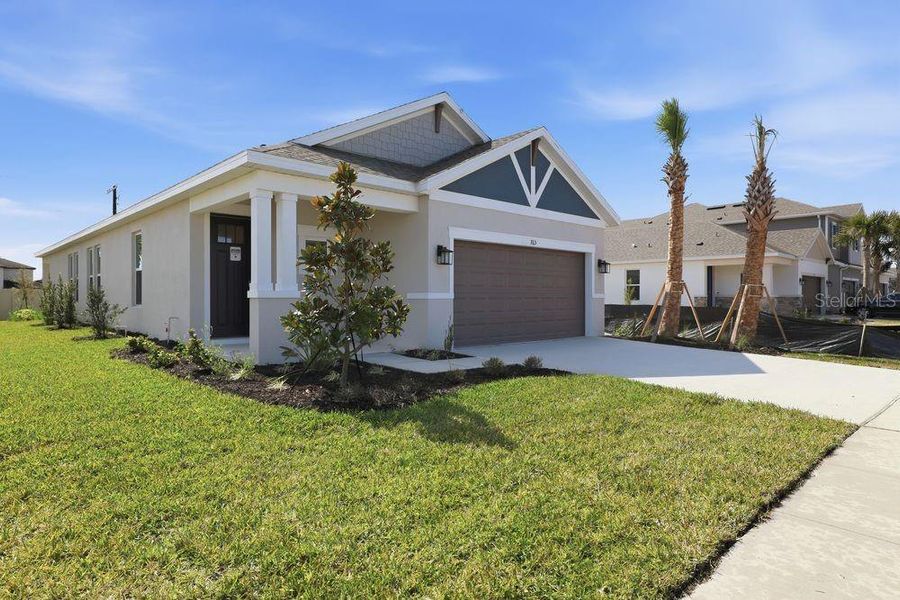 Front exterior of a new home in Indigo Creek, Apollo Beach, FL, highlighting curb appeal (Image 1). Front exterior of a new home in Indigo Creek, Apollo Beach, FL, highlighting curb appeal (Image 1).