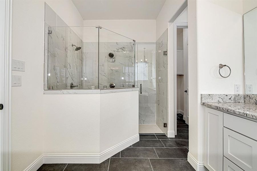 Bathroom with tile patterned flooring, vanity, and a shower with shower door