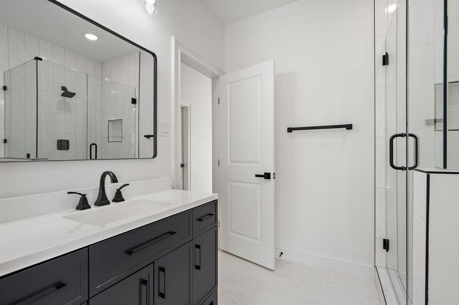 Bathroom featuring vanity and a shower stall Bathroom featuring vanity and a shower stall