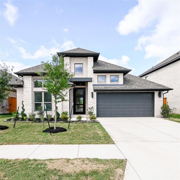 Front exterior of a new home in Crosswinds, Kyle, TX, highlighting curb appeal (Image 16). Front exterior of a new home in Crosswinds, Kyle, TX, highlighting curb appeal (Image 16).