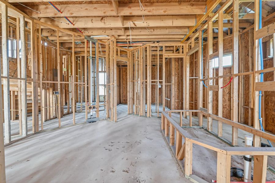 Open unfinished space showcasing framing and build progress.