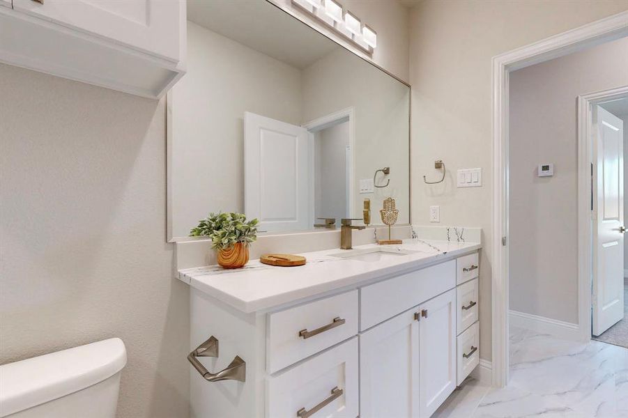 Hall Bathroom with tile flooring, vanity, and toilet