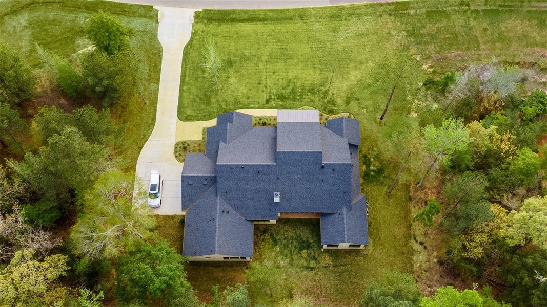 The aerial picture shows how this formidable property sits well back from the road with a long extended private driveway which opens up to double wide additional parking space and access to the 3-car garage.