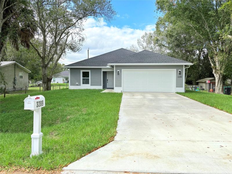 Front exterior of a new home in , Okeechobee, FL, highlighting curb appeal (Image 24).